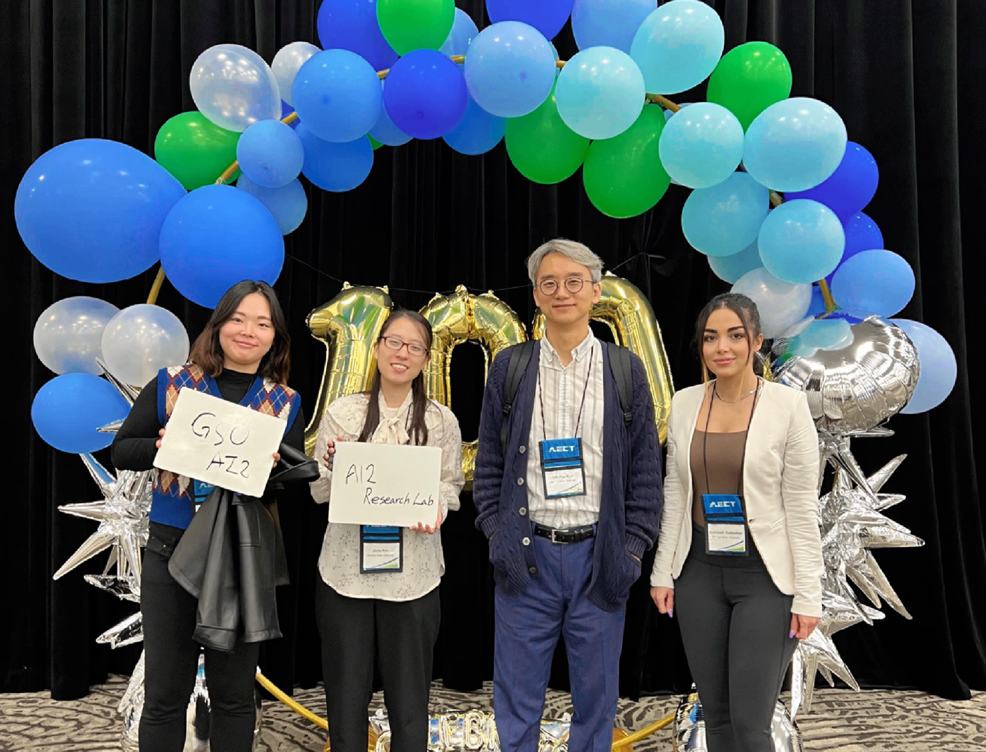 Research team at AECT conference with balloon decorations
