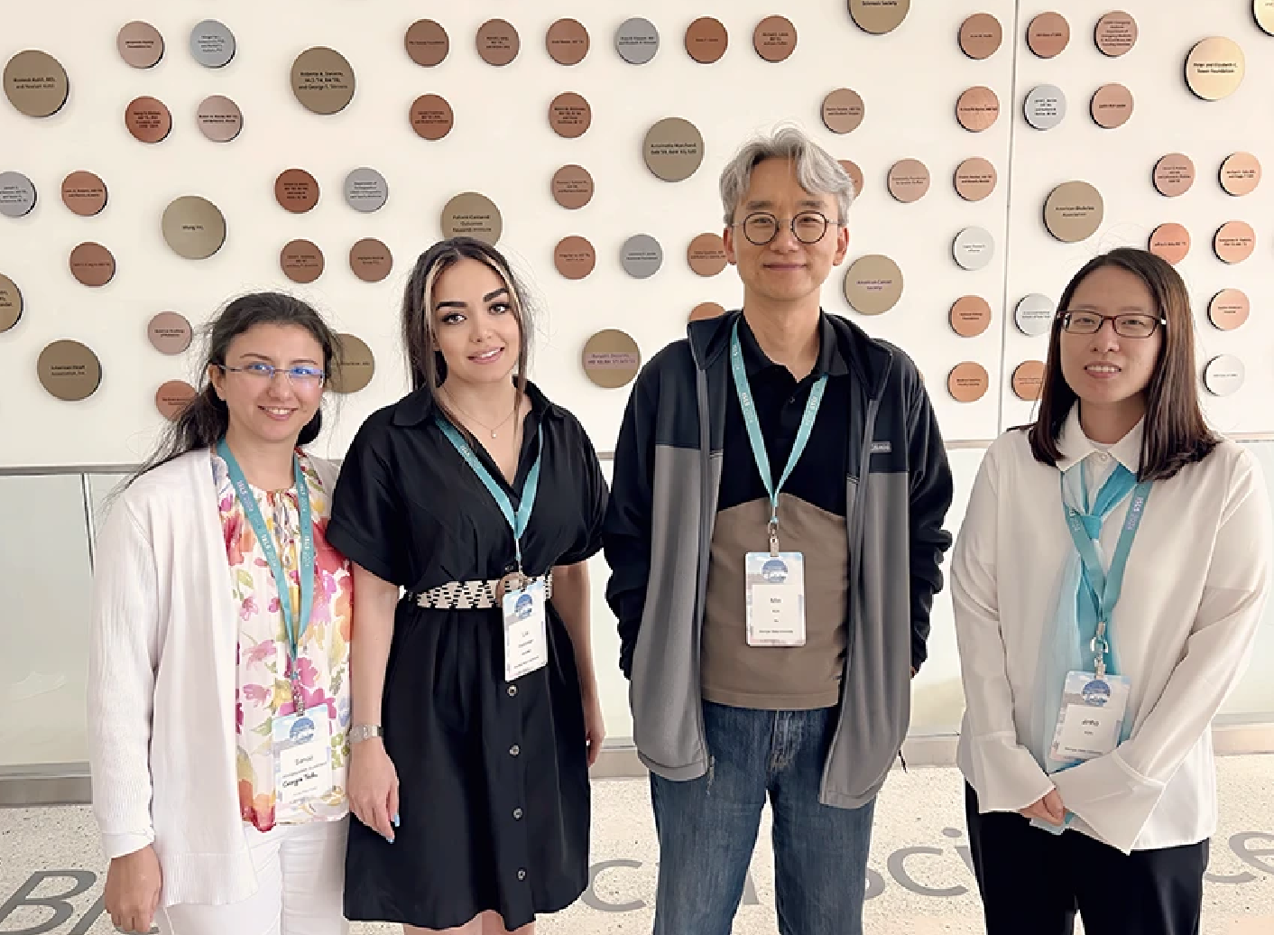 Research team standing in front of circular wall display