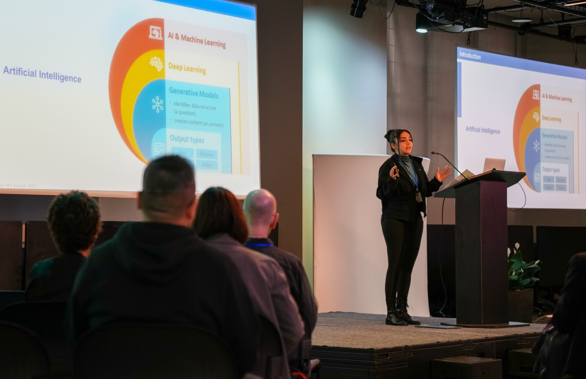 Researcher presenting about AI and Machine Learning with colorful diagram on screen